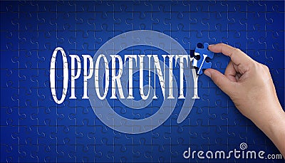 Opportunity word on Jigsaw puzzle. Man hand holding a blue puzzle to complete the word Opportunity divided over them conceptual o Stock Photo